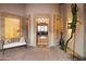 Elegant entryway with arched doorway, chandelier, and seating area at 25313 N 114Th St, Scottsdale, AZ 85255