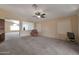 Relaxing living room with neutral carpeting and a view to kitchen at 10923 W Escuda Dr, Sun City, AZ 85373