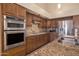 Modern kitchen with wood cabinets and granite countertops at 10923 W Escuda Dr, Sun City, AZ 85373