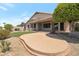 Landscaped backyard with a large patio at 10923 W Escuda Dr, Sun City, AZ 85373