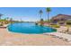 Calm lake with houses and lush landscaping at 10923 W Escuda Dr, Sun City, AZ 85373