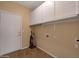 Laundry room with cabinets and vinyl flooring at 10923 W Escuda Dr, Sun City, AZ 85373