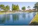 Tranquil community lake with a central fountain at 10923 W Escuda Dr, Sun City, AZ 85373
