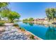 Peaceful lakefront community with homes and walkways at 10923 W Escuda Dr, Sun City, AZ 85373
