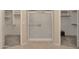 Bathroom with walk-in shower and double closets at 10923 W Escuda Dr, Sun City, AZ 85373