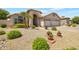 Two-story house with arched entry and mature landscaping at 10923 W Escuda Dr, Sun City, AZ 85373
