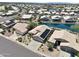 Aerial view of houses with solar panels near a lake at 10923 W Escuda Dr, Sun City, AZ 85373