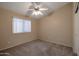 Spacious bedroom with ceiling fan and carpet at 10923 W Escuda Dr, Sun City, AZ 85373