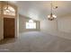 Bright living room with neutral carpeting and high ceilings at 10923 W Escuda Dr, Sun City, AZ 85373