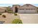 Single story home with two-car garage and desert landscaping at 10923 W Escuda Dr, Sun City, AZ 85373
