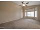 Spacious bedroom with a door leading to the backyard at 10923 W Escuda Dr, Sun City, AZ 85373