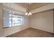 Bright dining area with large window and tile flooring at 10923 W Escuda Dr, Sun City, AZ 85373