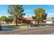 Single-story home with tile roof, mature landscaping, and a three-car garage at 4112 W Paradise Ln, Phoenix, AZ 85053