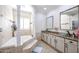 Bathroom with a large vanity, soaking tub, and separate shower at 4112 W Paradise Ln, Phoenix, AZ 85053