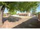 Spacious backyard with mature trees and large grassy area at 4112 W Paradise Ln, Phoenix, AZ 85053
