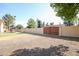 Large backyard with grassy area, wooden gate, and trampoline at 4112 W Paradise Ln, Phoenix, AZ 85053