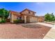 Two-story house with tile roof, attached garage, and landscaped yard at 5971 W Venus Way, Chandler, AZ 85226