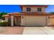 Two-story house with a tan exterior, a tile roof, and a two-car garage at 5971 W Venus Way, Chandler, AZ 85226