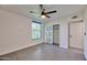 Bedroom with large window, ceiling fan and closet at 5324 E Hillery Dr, Scottsdale, AZ 85254