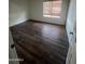 Large bedroom with dark brown laminate flooring and window coverings at 1966 E Calle De Arcos --, Tempe, AZ 85284