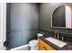 Powder room with dark gray walls and wood vanity at 9539 W Villa Chula --, Peoria, AZ 85383