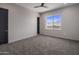Well-lit bedroom with grey carpet, ceiling fan and window at 19617 N 39Th Dr, Glendale, AZ 85308