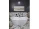 Luxurious bathroom featuring a freestanding tub and marble tile at 19617 N 39Th Dr, Glendale, AZ 85308