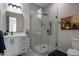 Modern bathroom with white vanity, glass shower, and decorative art at 19617 N 39Th Dr, Glendale, AZ 85308