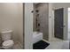 Clean bathroom with toilet, bathtub, and grey tile shower surround at 19617 N 39Th Dr, Glendale, AZ 85308