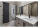 Elegant bathroom with double vanity, large mirror, and walk-in shower at 19617 N 39Th Dr, Glendale, AZ 85308