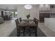 Open dining room with dark wood table and modern pendant lighting at 19617 N 39Th Dr, Glendale, AZ 85308