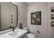 Modern bathroom with single vanity, large mirror and toilet at 19617 N 39Th Dr, Glendale, AZ 85308