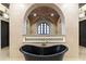 Stunning bathroom with a freestanding tub and a large shower with arched window at 21868 E Stacey Rd, Queen Creek, AZ 85142