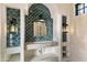 Unique bathroom vanity with a stunning teal fish-scale tile feature wall at 21868 E Stacey Rd, Queen Creek, AZ 85142