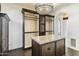 Spacious walk-in closet with center island and lighting at 21868 E Stacey Rd, Queen Creek, AZ 85142