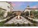 Expansive courtyard with central fire pit and elegant stonework at 21868 E Stacey Rd, Queen Creek, AZ 85142