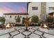 Charming courtyard with fire pits, landscaping, and artistic sculpture at 21868 E Stacey Rd, Queen Creek, AZ 85142