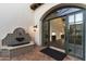 Inviting entryway features a beautiful fountain and arched doorway leading inside at 21868 E Stacey Rd, Queen Creek, AZ 85142