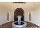 Stunning entryway featuring a central fountain and arched doorways at 21868 E Stacey Rd, Queen Creek, AZ 85142