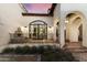 Elegant home exterior with arched entryway, fountain, and meticulously landscaped grounds at 21868 E Stacey Rd, Queen Creek, AZ 85142