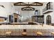 Gourmet kitchen boasts expansive island, high-end appliances, and custom cabinetry at 21868 E Stacey Rd, Queen Creek, AZ 85142