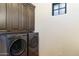 Laundry room with dark wood cabinets and LG appliances at 21868 E Stacey Rd, Queen Creek, AZ 85142