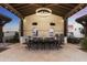 Outdoor kitchen with large dining table and high-end appliances at 21868 E Stacey Rd, Queen Creek, AZ 85142