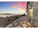 Elegant patio with stone flooring and wrought iron railing, offering scenic sunset views at 21868 E Stacey Rd, Queen Creek, AZ 85142