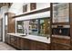 Elegant wet bar with sink, appliances, and pool view at 21868 E Stacey Rd, Queen Creek, AZ 85142