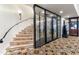 Elegant wine cellar with circular staircase and glass walls at 21868 E Stacey Rd, Queen Creek, AZ 85142