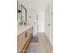 Clean bathroom with a double vanity, modern lighting, and stacked washer/dryer at 7350 N Via Paseo Del Sur -- # P202, Scottsdale, AZ 85258