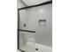 Clean shower with gray tiled walls and a frameless glass door at 7350 N Via Paseo Del Sur -- # P202, Scottsdale, AZ 85258