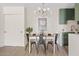 Bright dining area with a modern kitchen and stylish light fixture at 7350 N Via Paseo Del Sur -- # P202, Scottsdale, AZ 85258