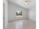 Bright bedroom with tile flooring and a large window at 305 N Miller Rd, Buckeye, AZ 85326